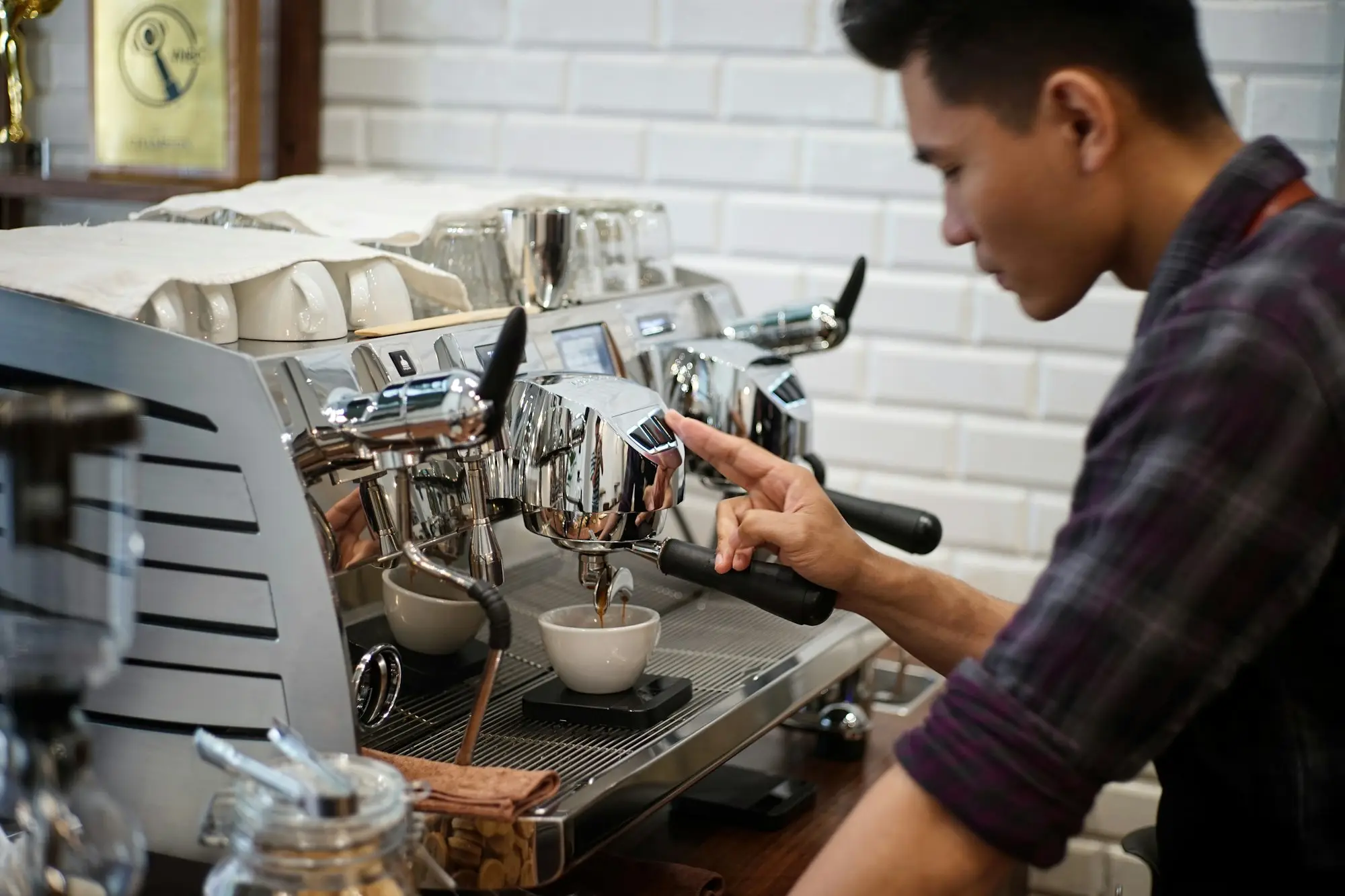 Barista making a coffee at the café espresso machine
