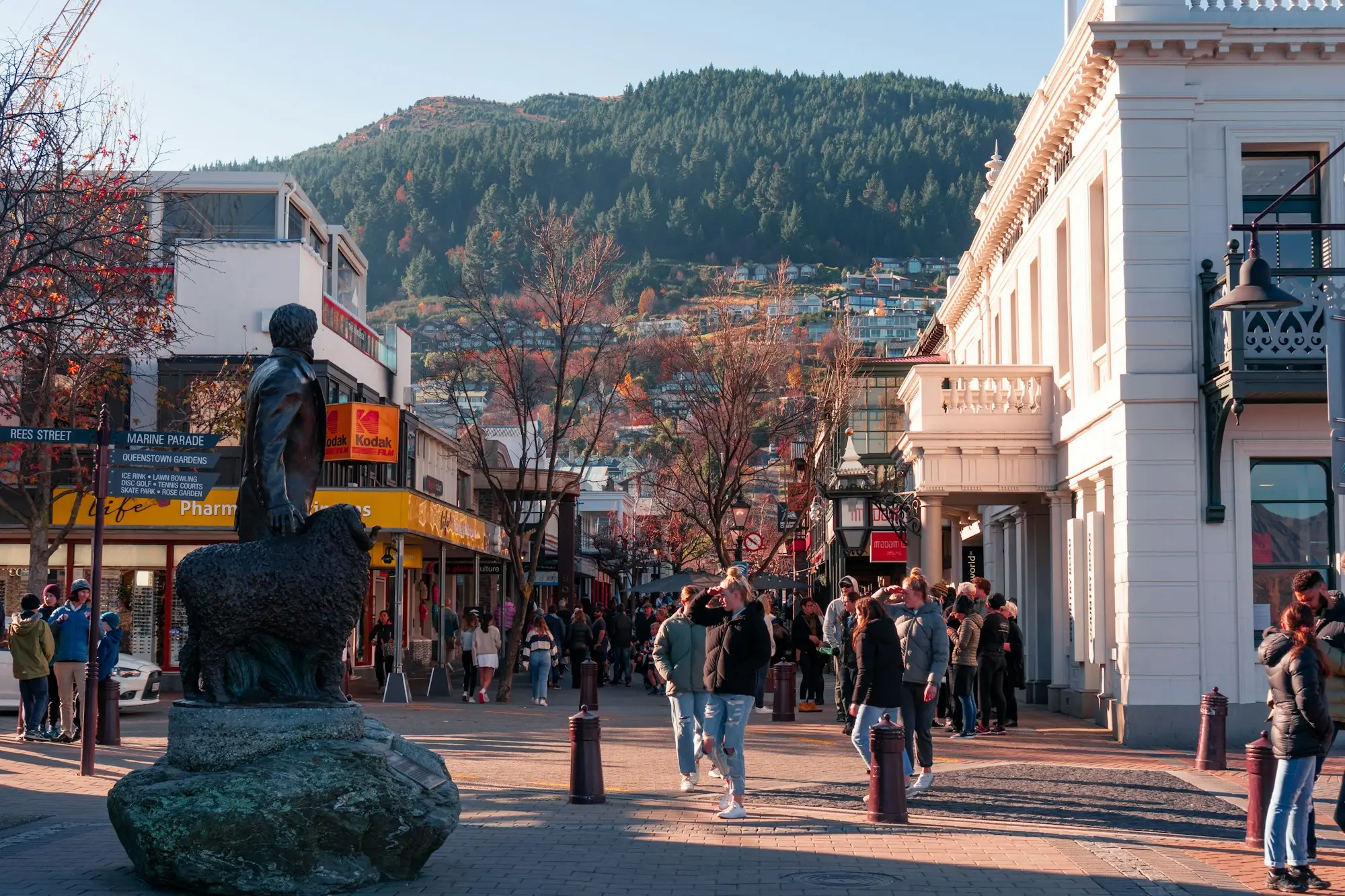 People walking past shops in a mountain town