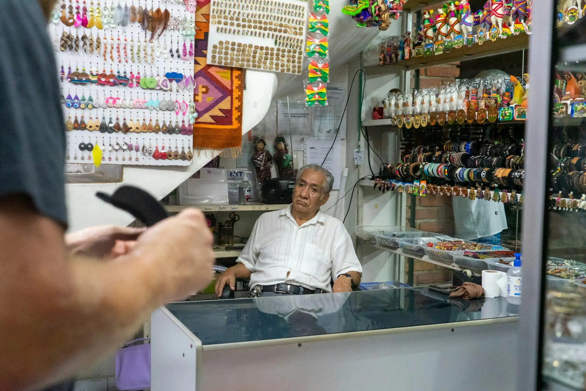 Shop owner standing behind his counter