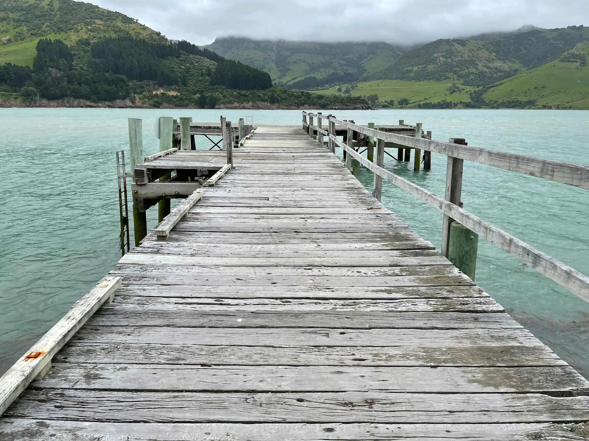 Wooden jetty reaching into calm water